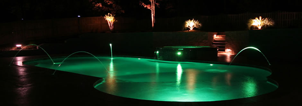 pool with fire and water features lit by LED lights